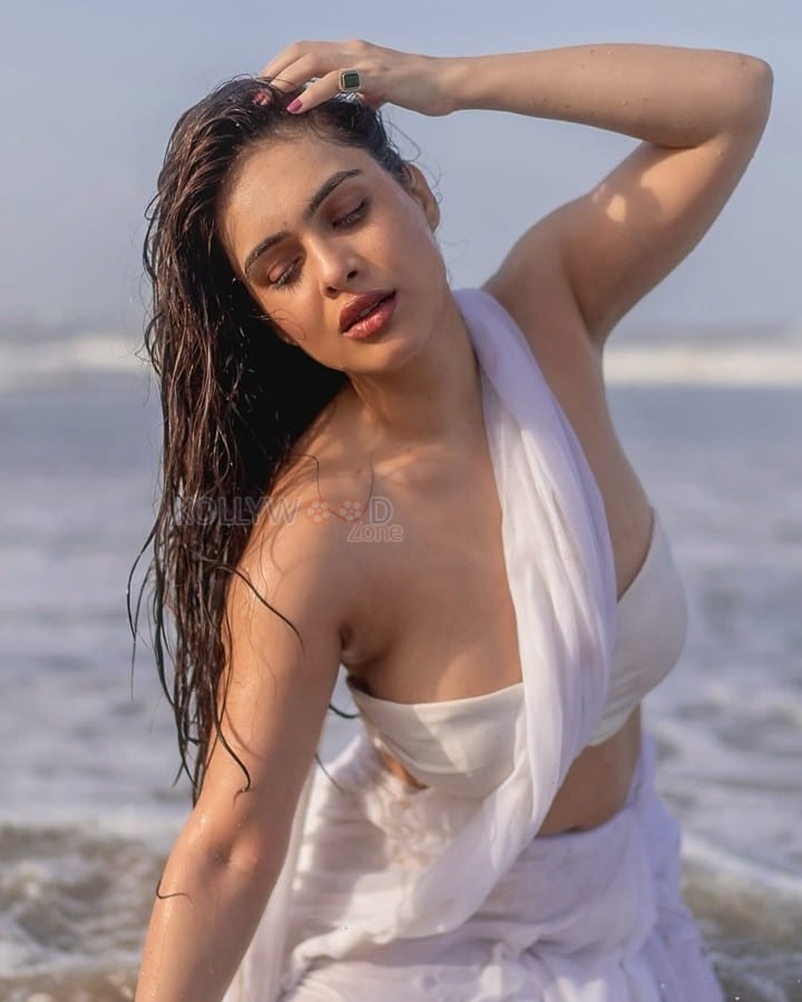 Bold Neha Malik in a White Saree at the Beach Photos 03