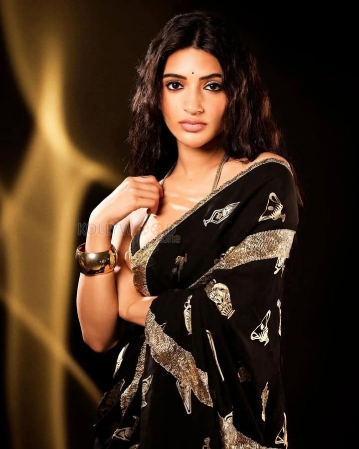 Bold Sreeleela in a Black Saree with Metallic Gold Motifs and Sleeveless Deep Cut Blouse Photos 02