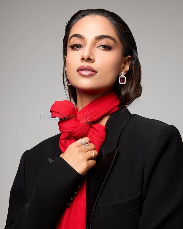 Adorable Meenakshi Chaudhary in a Black and Red Suit Photos 04