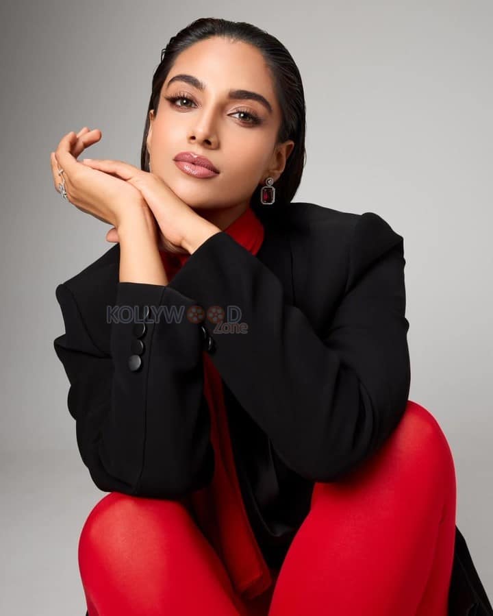 Adorable Meenakshi Chaudhary in a Black and Red Suit Photos 07