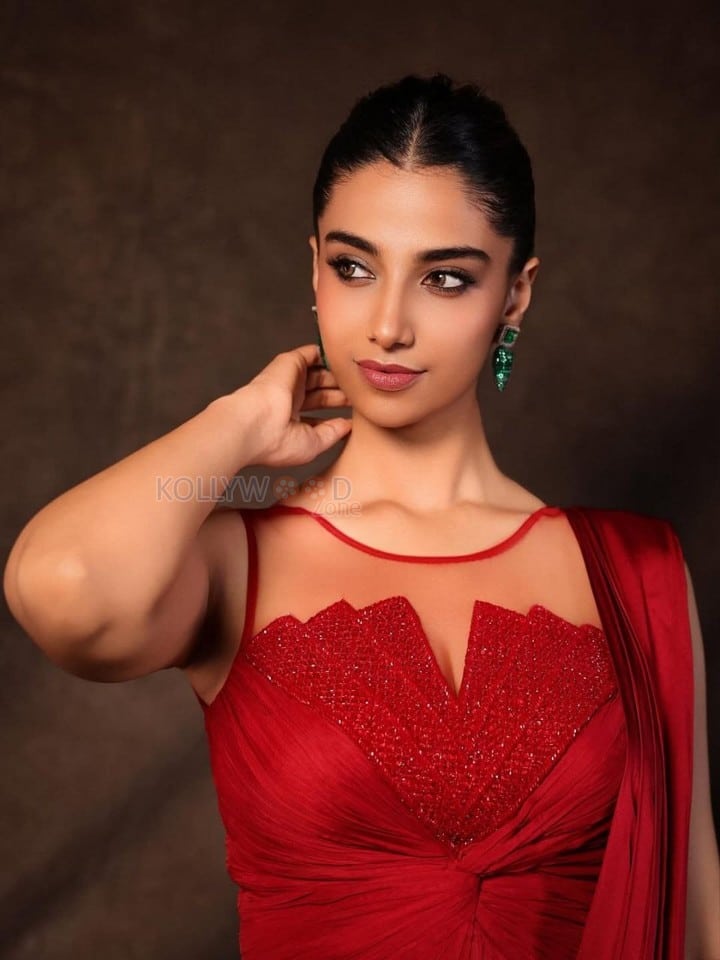 Glamorous Meenakshi Chaudhary in a Red Satin Lehenga Saree with a Embroidered Sheer Net Round Neck Photos 01