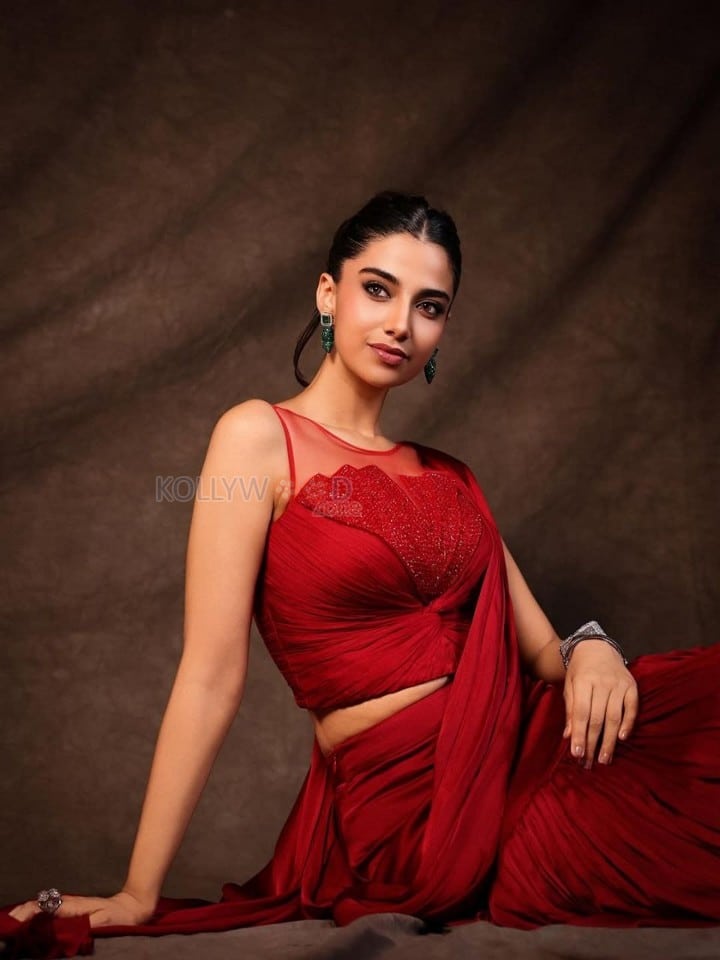 Glamorous Meenakshi Chaudhary in a Red Satin Lehenga Saree with a Embroidered Sheer Net Round Neck Photos 02