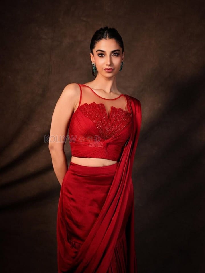 Glamorous Meenakshi Chaudhary in a Red Satin Lehenga Saree with a Embroidered Sheer Net Round Neck Photos 03