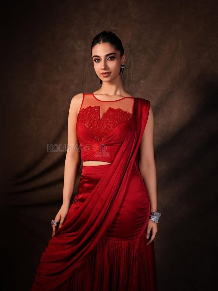 Glamorous Meenakshi Chaudhary in a Red Satin Lehenga Saree with a Embroidered Sheer Net Round Neck Photos 04