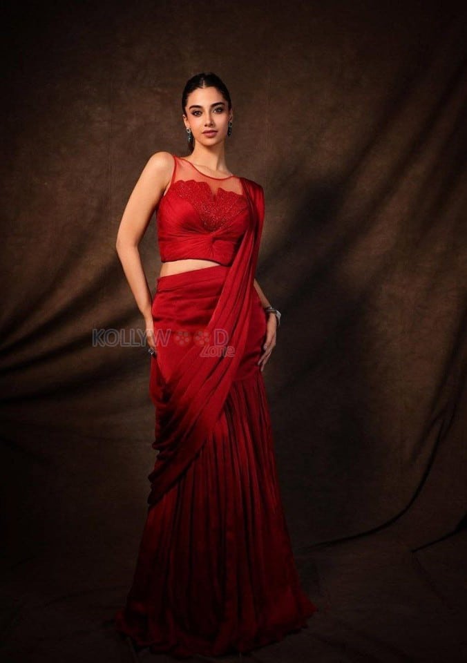 Glamorous Meenakshi Chaudhary in a Red Satin Lehenga Saree with a Embroidered Sheer Net Round Neck Photos 05