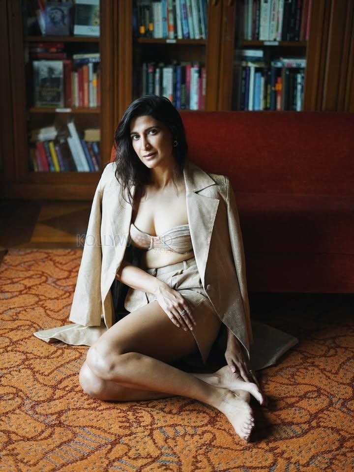 Stunning Cleavage in a Golden long Coat with a Bralette and Mini Skirt Photos 03
