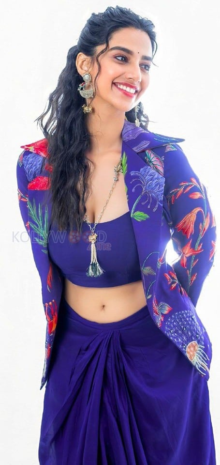 Stunning Meenakshi Chaudhary in a Vibrant Blue Bralette with Matching Skirt and a Stylish Shrug Photos 03