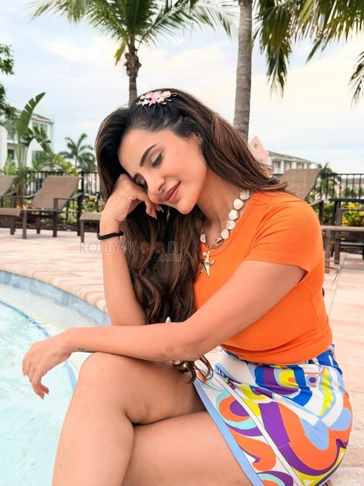 Charming Ashu Reddy in an Orange Top and Colourful Skirt near the Poolside Photos 03