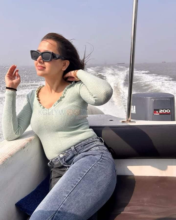 Actress Tejasswi Prakash seated on a Speedboat Photos 01