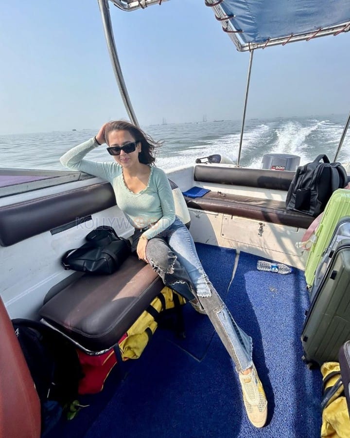 Actress Tejasswi Prakash seated on a Speedboat Photos 02