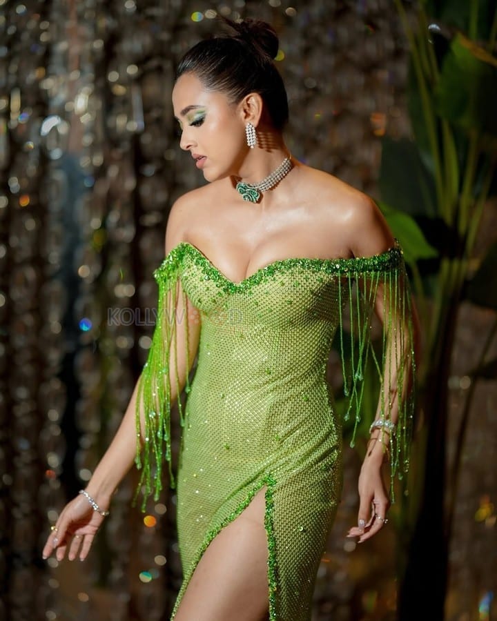 Stunning Bold Tejasswi Prakash in a Green Thigh Slit Off Shoulder Dress Photos 03
