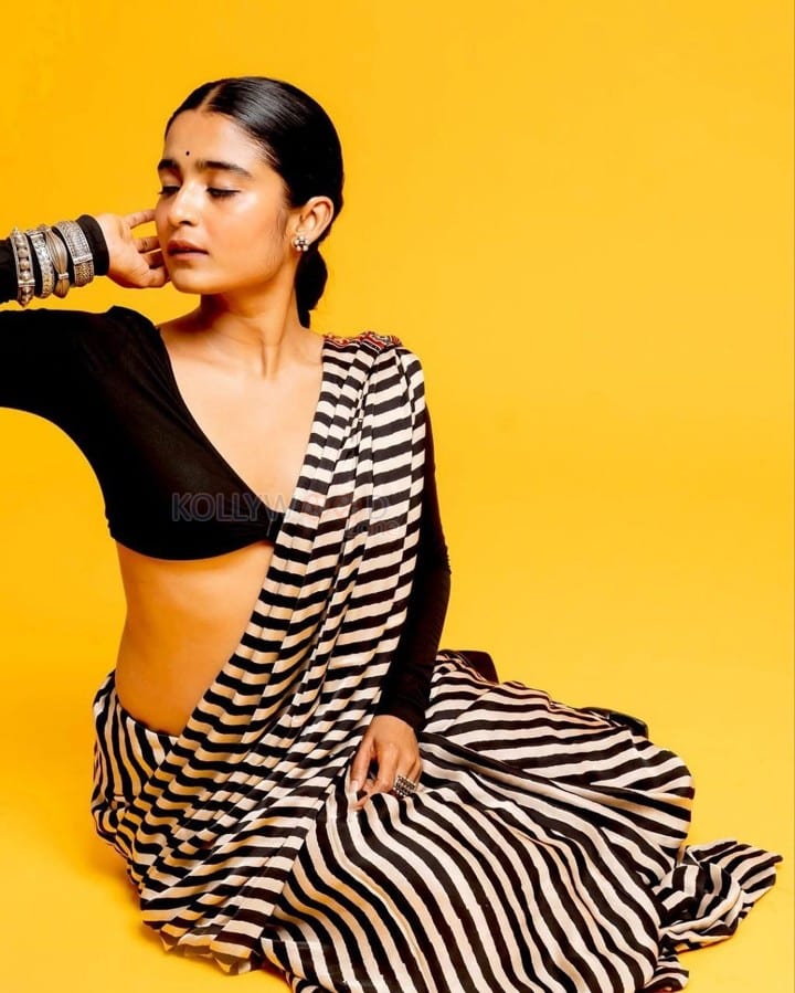 3BHK Actress Chaithra J Achar in a Striped Black and White Saree with a Deep Cut Long Sleeve Blouse Photos 01