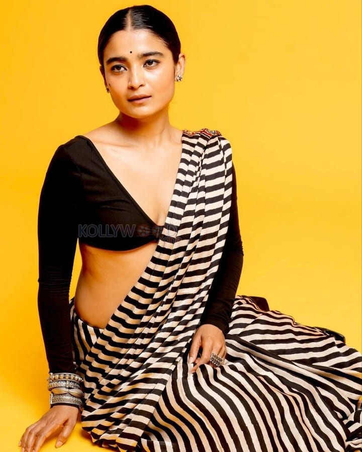 3BHK Actress Chaithra J Achar in a Striped Black and White Saree with a Deep Cut Long Sleeve Blouse Photos 05