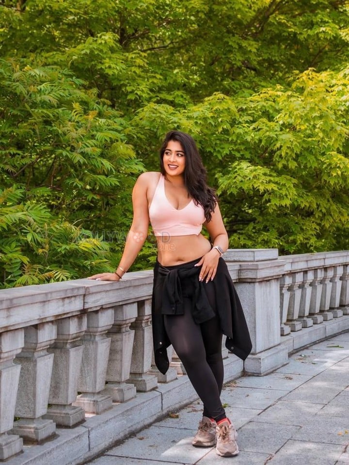 Beautiful Nikita Sharma in a Light Pink Sports Bra and Black Leggings Photos 01