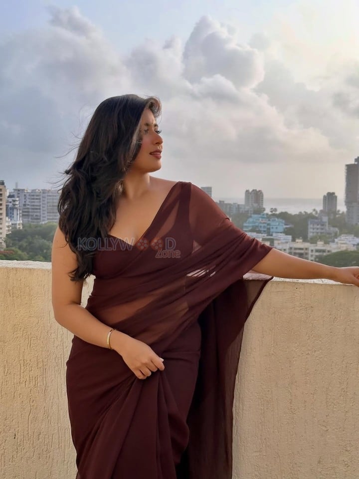Big Beauty Nikita Sharma in a Maroon Saree with Sleeveless Blouse Photos 02