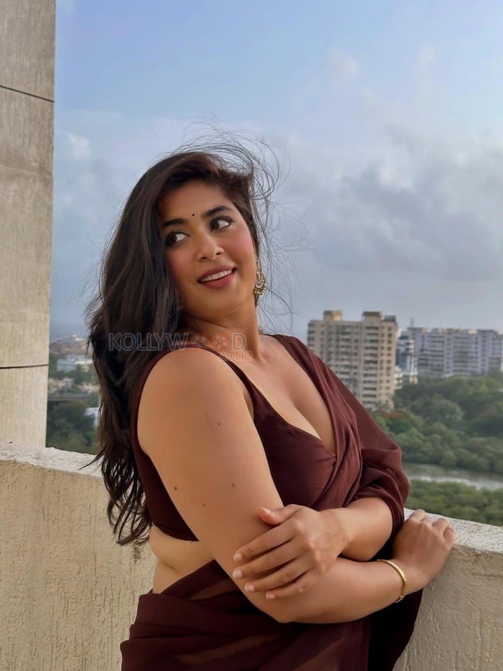 Big Beauty Nikita Sharma in a Maroon Saree with Sleeveless Blouse Photos 04