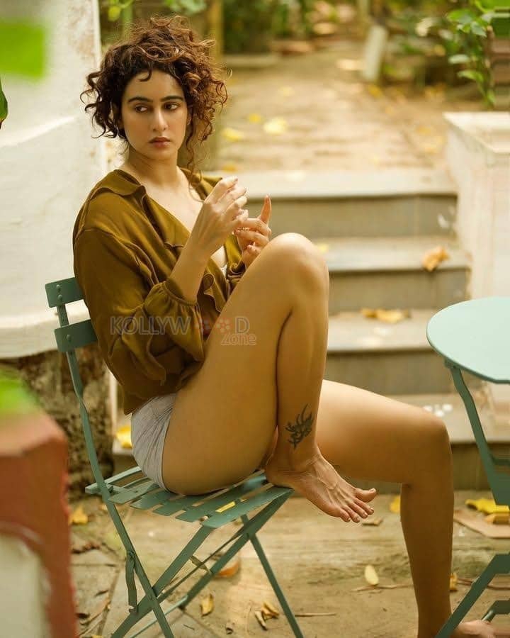 Adorable Megha Shukla in a Mustard Brown Shirt and Boy Shorts Photos 01