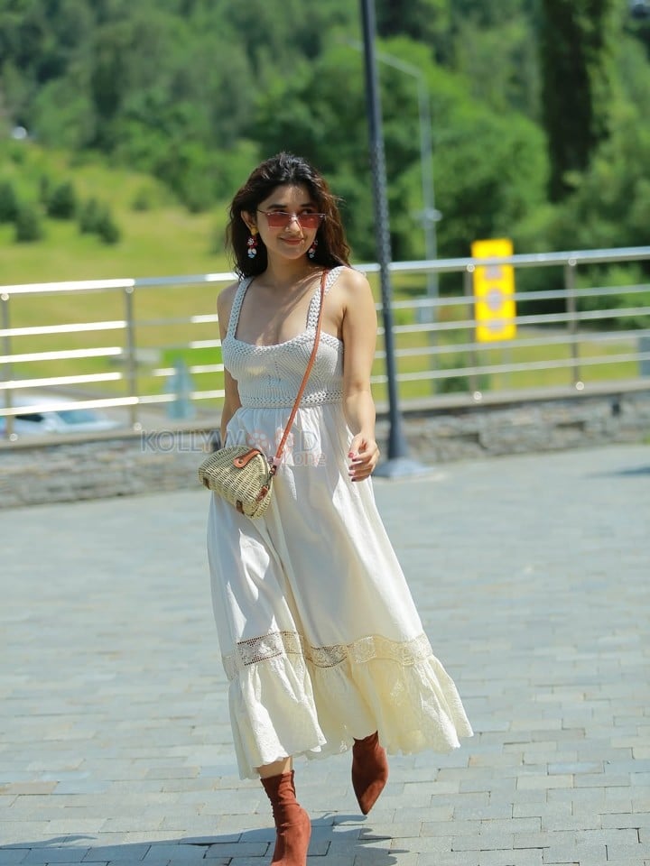 Cute Kanika Mann in a White Shoulder Straps Sleeveless Maxi Dress with Brown Boots Photos 04