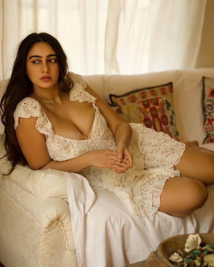 Glamorous Megha Shukla Cleavage in a White Lace Deep Neck Short Dress Photos 03