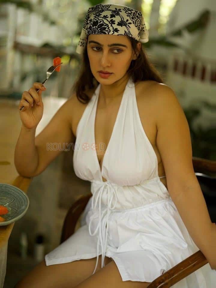 Seductive Beauty Megha Shukla in a White Halter Neck Backless Deep Neck Babydoll Dress Photos 01