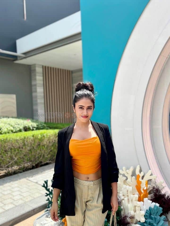 Sexy Shobhita Rana in an Orange Crop Top Black Jacket and Beige Pant Pictures 02