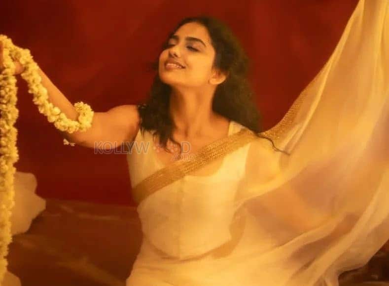 Beautiful Mamitha Baiju in a White Transparent Saree with Gold Border and Sleeveless Blouse Photos 01