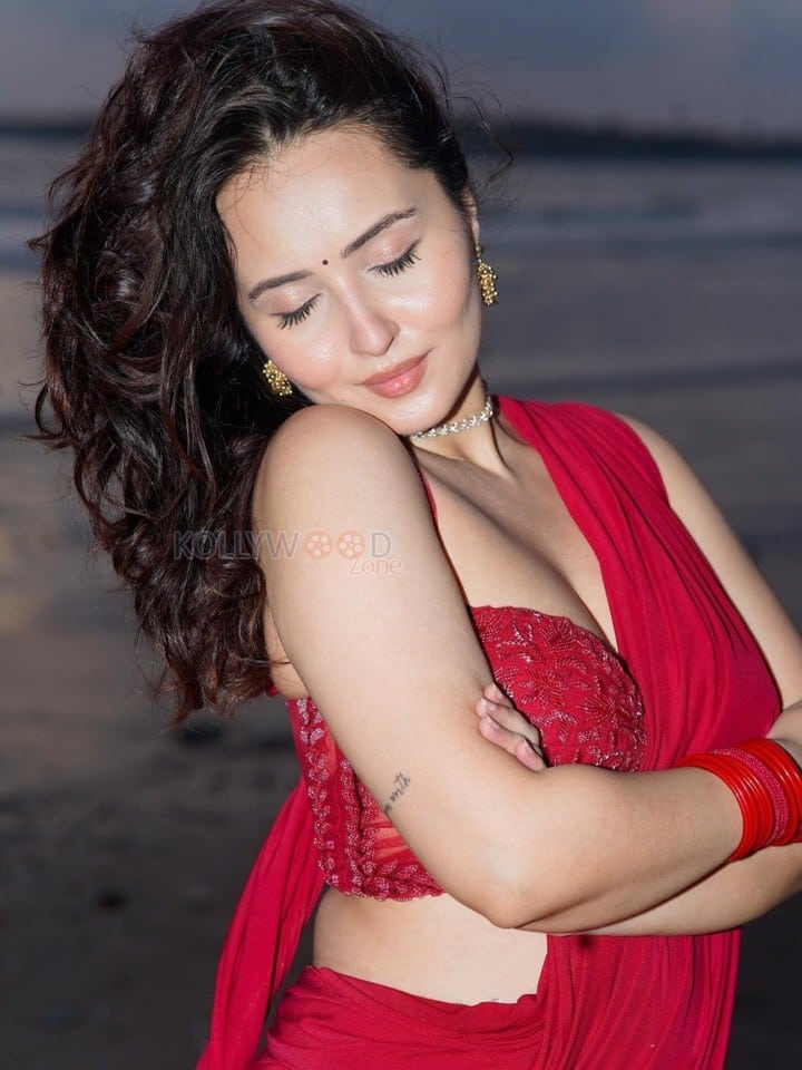 Glamorous Varsha Rekhate in a Red Saree with an Embellished Sleeveless Blouse Photos 01