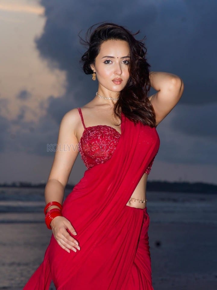 Glamorous Varsha Rekhate in a Red Saree with an Embellished Sleeveless Blouse Photos 02