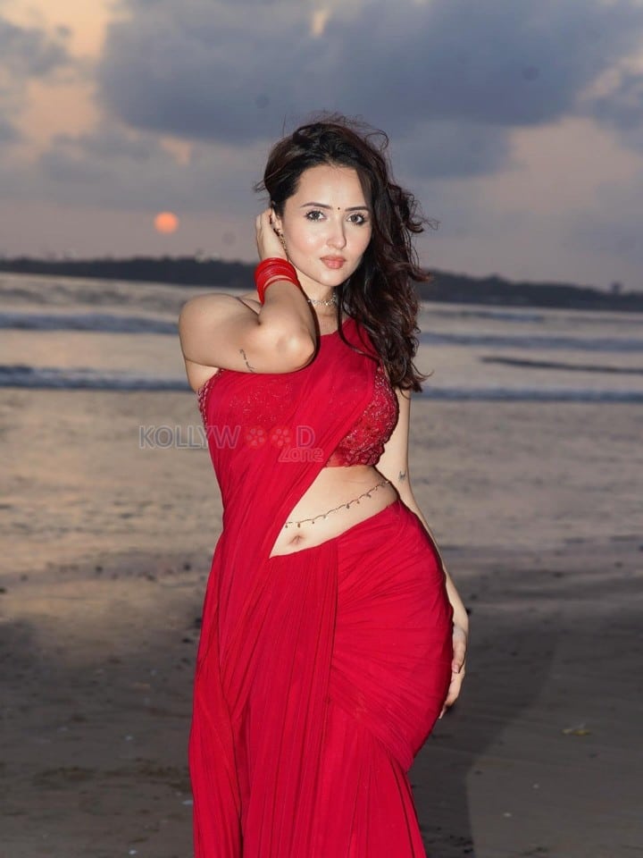 Glamorous Varsha Rekhate in a Red Saree with an Embellished Sleeveless Blouse Photos 04