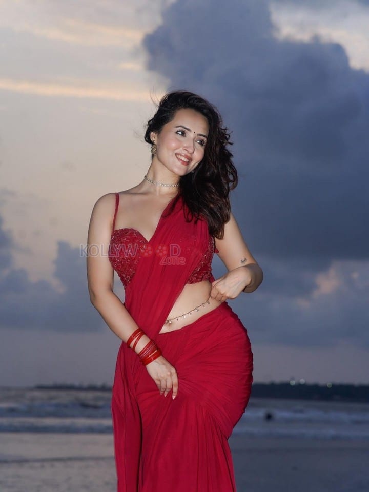 Glamorous Varsha Rekhate in a Red Saree with an Embellished Sleeveless Blouse Photos 06