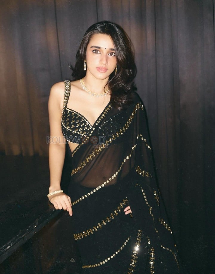 Sexy Nuveksha in a Black Saree with Delicate Golden Sequin Stripes and a Sleeveless Blouse Pictures 02