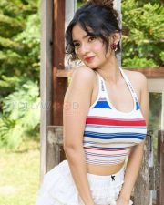 Charming Actress Avneet Kaur in a Striped Halter Crop Top White Ruffle Mini Skirt Photos 03