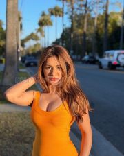 Stylish Actress Avneet Kaur in a Orange Tank Top and Blue Jeans Photos 06
