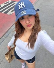 Stylish Actress Avneet Kaur in a White Long sleeve Top and Navy Polka Dot Shorts Photos 04