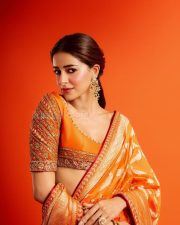 Actress Ananya Panday in a Vibrant Orange Banarasi Brocade Saree by Manish Malhotra with a Heavily Embroidered Elbow Length Blouse Pictures 02