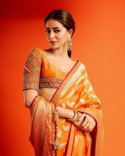 Actress Ananya Panday in a Vibrant Orange Banarasi Brocade Saree by Manish Malhotra with a Heavily Embroidered Elbow Length Blouse Pictures 04