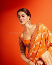Actress Ananya Panday in a Vibrant Orange Banarasi Brocade Saree by Manish Malhotra with a Heavily Embroidered Elbow Length Blouse Pictures 05