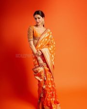 Actress Ananya Panday in a Vibrant Orange Banarasi Brocade Saree by Manish Malhotra with a Heavily Embroidered Elbow Length Blouse Pictures 06