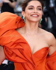 Actress Deepika Padukone wearing a Red Gown and Showing Cleavage Photo 01