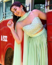 Actress Nikki Galrani in a Light Green Lehenga Set on a Red Bus Photos 02