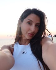 Alluring Actress Nora Fatehi in a Floral Print Backless Halter Dress Photos 02