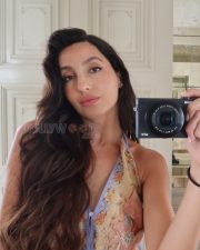 Alluring Actress Nora Fatehi in a Floral Print Backless Halter Dress Photos 03