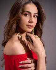 Alluring Actress Rakul Preet in a crimson red strapless bardot top with gold hoop earrings photos 04