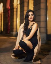 Alluring Malvika Sharma in a Black Peplum Top with a Deep Neckline with Matching Shorts and Long Tan Overcoat Photos 02