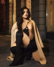 Alluring Malvika Sharma in a Black Peplum Top with a Deep Neckline with Matching Shorts and Long Tan Overcoat Photos 03