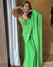 Beautiful Pooja Hegde in a Green Embroidered Saree with Sleeveless Blouse Photos 01
