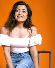 Beauty Queen Rashmika Mandanna in a White Off Shoulder Top and Denim Pant Photos 01