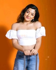 Beauty Queen Rashmika Mandanna in a White Off Shoulder Top and Denim Pant Photos 04