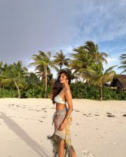 Breathtaking Actress Malavika Mohanan in a White Bikini Top and Floral Beach Sarong Photos 01