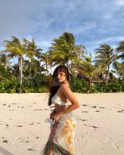 Breathtaking Actress Malavika Mohanan in a White Bikini Top and Floral Beach Sarong Photos 02